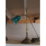 A good brass adjustable reading lamp with green glass shade.