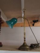 A good brass adjustable reading lamp with green glass shade.