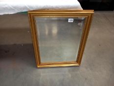 A gilded framed bevel edged mirror. Collect Only.