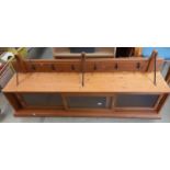 A mid 20th century long kitchen wall mounted unit with forge metal work