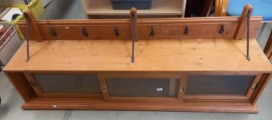 A mid 20th century long kitchen wall mounted unit with forge metal work