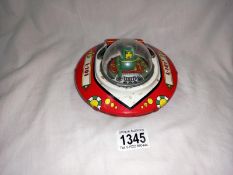 A tinplate wind up bump and go tin treasures, tin toy collectables UFO flying saucer. Diameter 13.