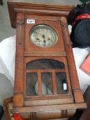 An early 20th century oak wall clock in working order, COLLECT ONLY.