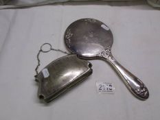 A silver backed hand mirror and a silver plate evening purse.