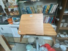 An artists bamboo storage table with lift top easel