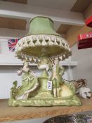 An early 20th century bisque figural table lamp.