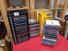 Some CD's with storage drawer chest and stacking pyramids