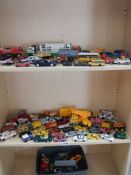 Three shelves of die cast and other cars for spares or repair.