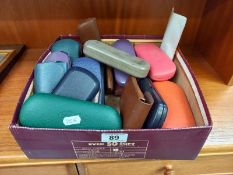 A box of spectacle cases including some with glasses