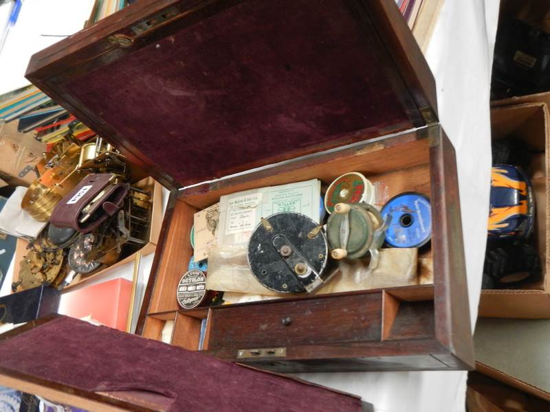 A quantity of vintage fishing reels etc., in a rosewood box.