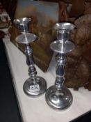 A pair of silvered candlesticks