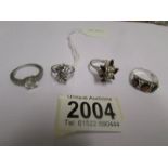 Four assorted silver rings.