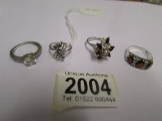 Four assorted silver rings.