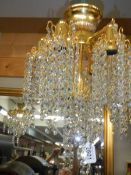 Two 24ct gold plated Swarovski crystal chandelier with four matching wall lights.