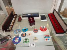 A quantity of miscellaneous items including badges, pens and watch etc