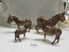 Three Beswick Donkeys and an unmarked donkey, all in good condition.