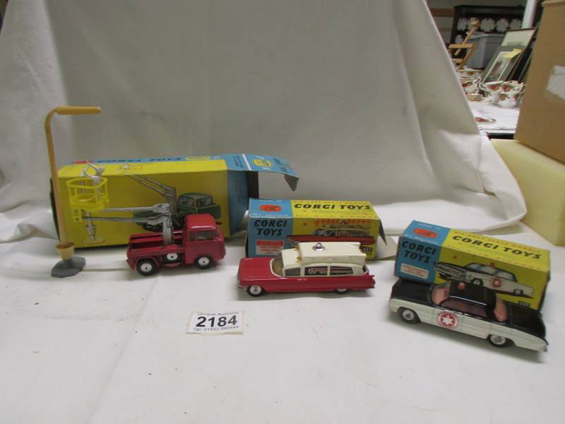 A boxed Corgi - 437 Cadillac ambulance, 237 Oldsmobile Sherrif car and Gift set No. 14 hydraulic