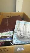Box of books and magazines concerning maritime history.