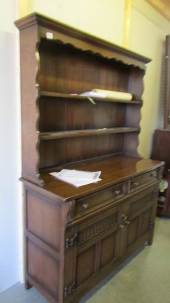 An open rack oak dresser. COLLECT ONLY.