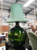 A large green carboy made into a table lamp Collect Only.