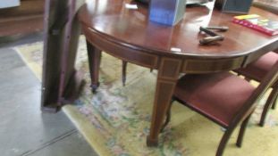 A mahogany oval extending dining table with two extra leaves, COLLECT ONLY.