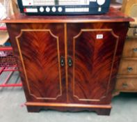 A dark wood stained 2 door cupboard with inner drawer. 79cm x 47cm x height 88cm. COLLECT ONLY.