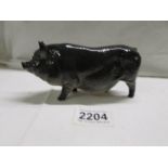 A Royal Doulton black pot bellied pig, in good condition.