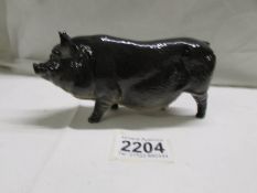 A Royal Doulton black pot bellied pig, in good condition.
