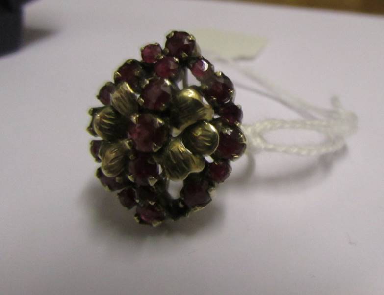 A yellow gold ring set garnets, marked 18k, (missing two stones), size N.