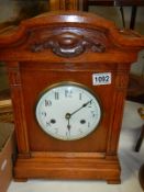 An early 20th century oak mantle clock in working order. Collect Only.