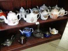 A good lot of collectable teapots including souvenir, pewter etc.,