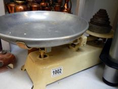 An old set of kitchen scales with weights