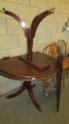 An oval double pedestal dining table with spare leaf. COLLECT ONLY.