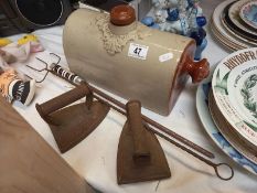 A stoneware footwarmer bottle, toasting fork, fire poker and 2 irons.