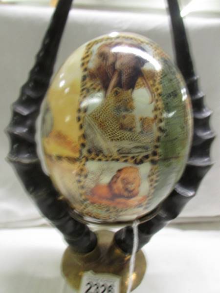 A decorated ostrich egg depicting elephants and other wild animals. - Image 5 of 5