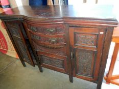 A carved wood panel sideboard