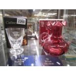 A boxed Caithness engraved vase and a boxed cranberry glass twin handled vase. Collect Only.