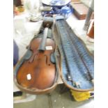 An old violin with two bows and in a wooden case.