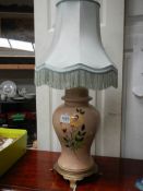 A painted table lamp complete with shade.