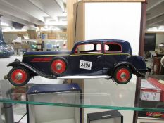 A large tinplate clockwork 1930's style car with opening doors and boot, 50 cm long.