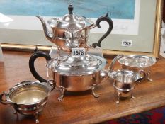 A three piece silver plate tea set and two other items.