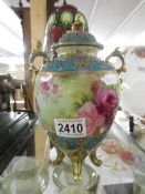 A continental porcelain floral decorated lidded vase.