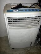 An oscillating mini electric air conditioner/heater