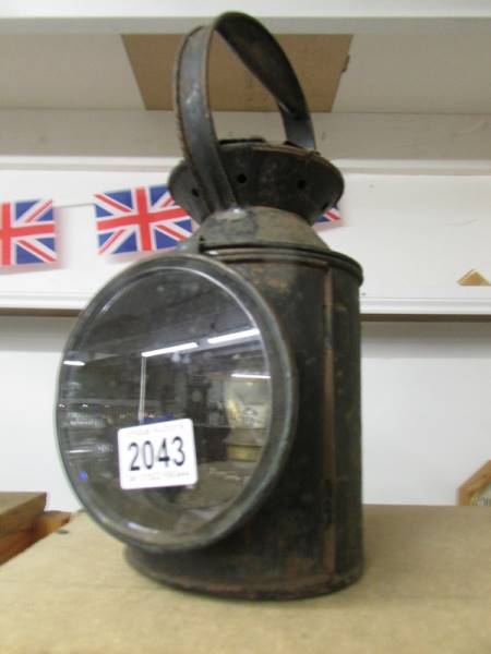 An early 20th century railway lamp with red and blue glass but clear glass missing.