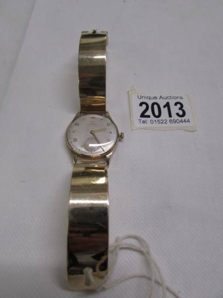 A 9ct gold Omega wrist watch on a 9ct gold strap, in working order.