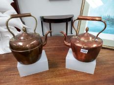 A pair of copper kettles