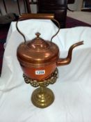 A Victorian copper kettle on Victorian brass trivet