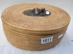 An unusual wicker oval box with carved wooden turtle on lid