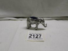 A white metal pin cushion in the form of an elephant.