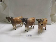 Three Beswick Jersey cows, all have damage to horns.